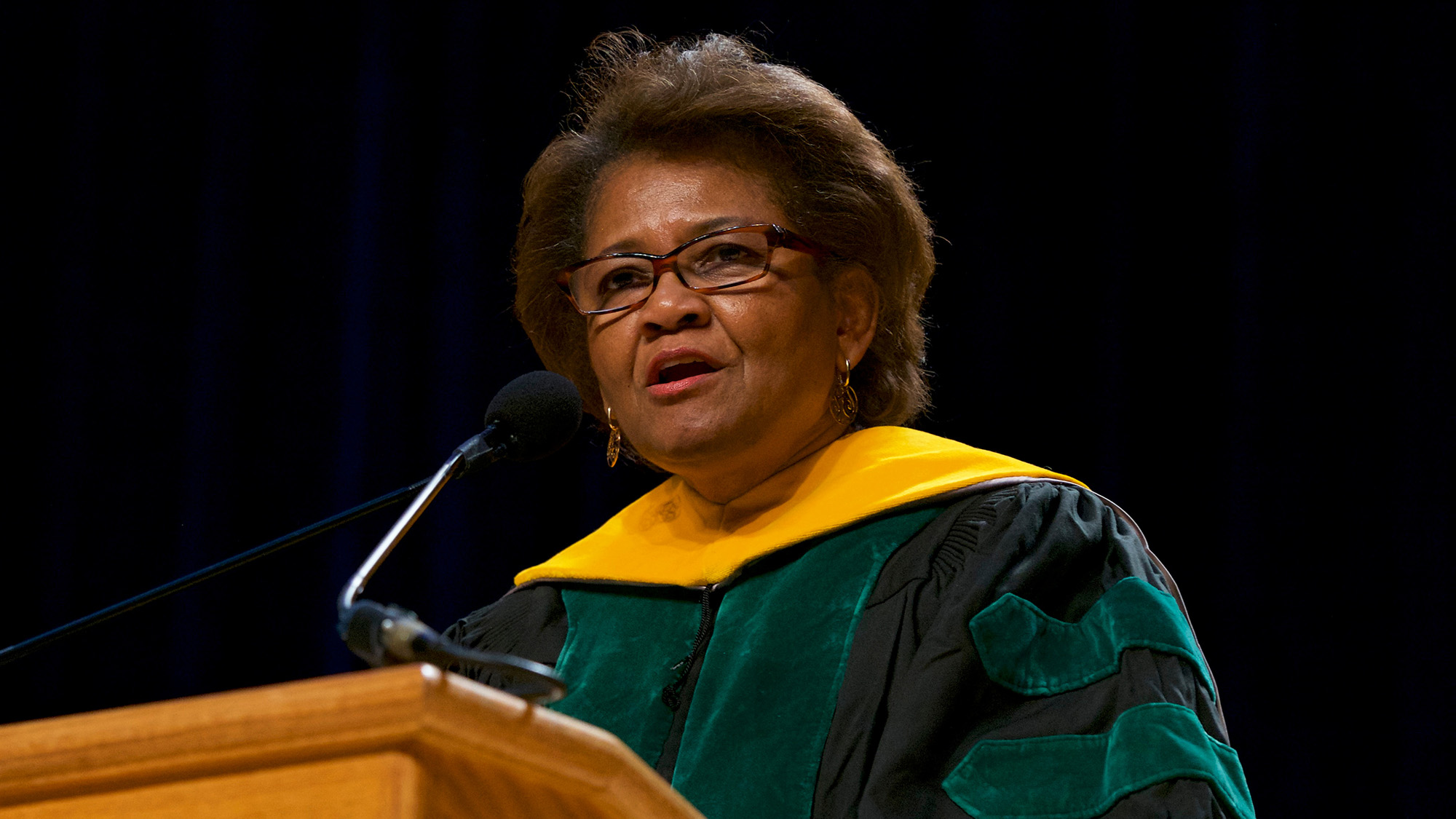 Dr. McCaskill-Stevens speaks at a podium during commencement