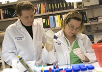 Two people work in a lab