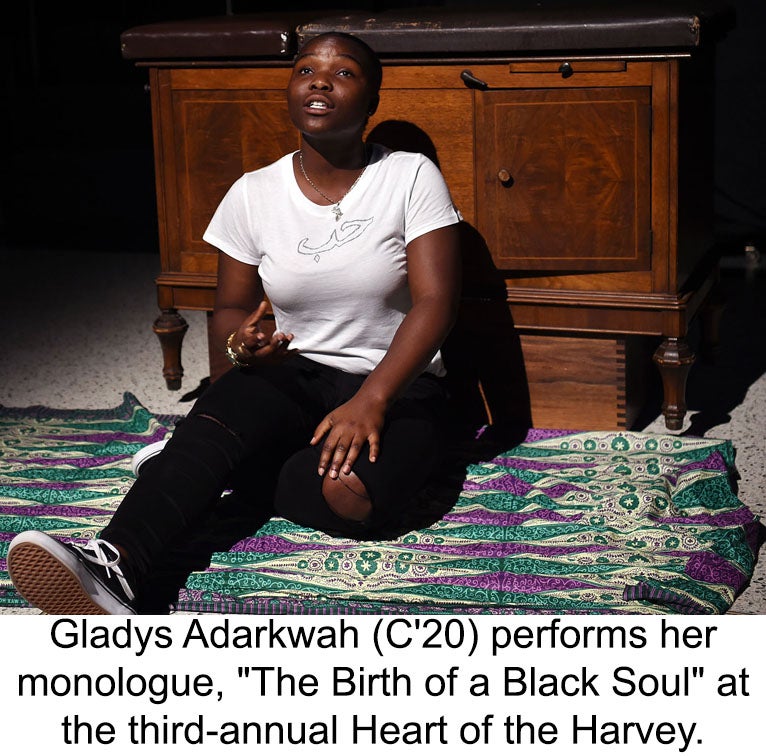 Gladys Adarkwah sits on a rug before a chest of drawers performing her monologue