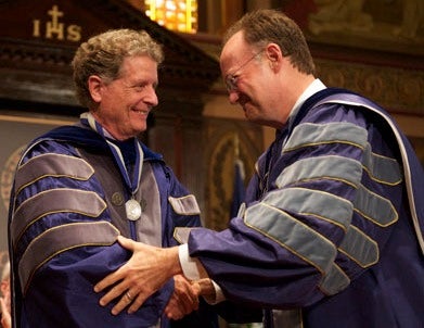 Richard Schlegel and Jack DeGioia shake hands