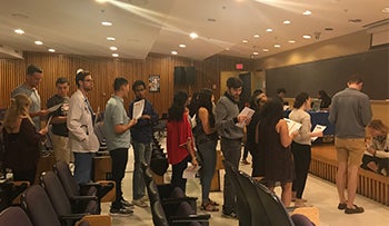 Students wait in line at the station for social services during the Capital Area Food Bank hunger simulation.