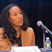 Dr. Ana Caskin speaks into a microphone