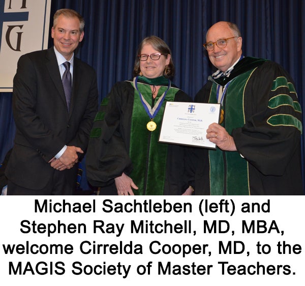 Michael Sachtleben (left) and Stephen Ray Mitchell (right) stand with Cirrelda Cooper (center) at the MAGIS Society of Master Teachers.