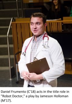 Man in a white coat holding a clipboard in a theater room