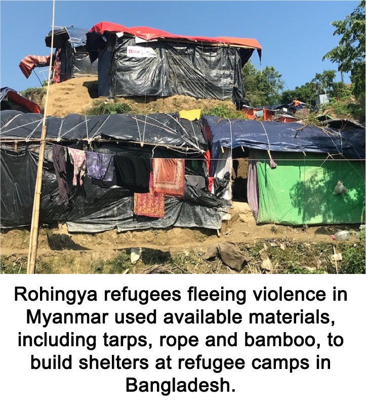 Tarps and rope have been used to fashion three makeshift tents with a clothesline strung before them.