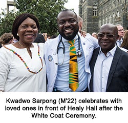 Kwadwo Sarpong (M'22) celebrates with loved ones in front of Healy Hall after the White Coat Ceremony.