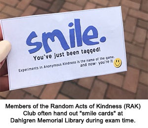 Members of the Random Acts of Kindness (RAK) Club often hand out "smile cards" at Dahlgren Memorial Library during exam time.