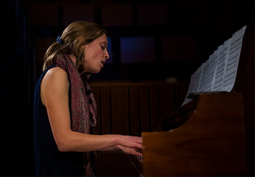 Student Marilyn McGowan plays a piano and sings