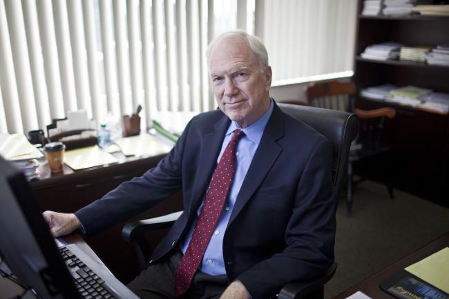 Ed Healton sits in his office at his desk