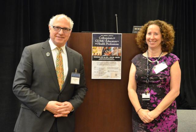 A man and woman stand on either side of a podium