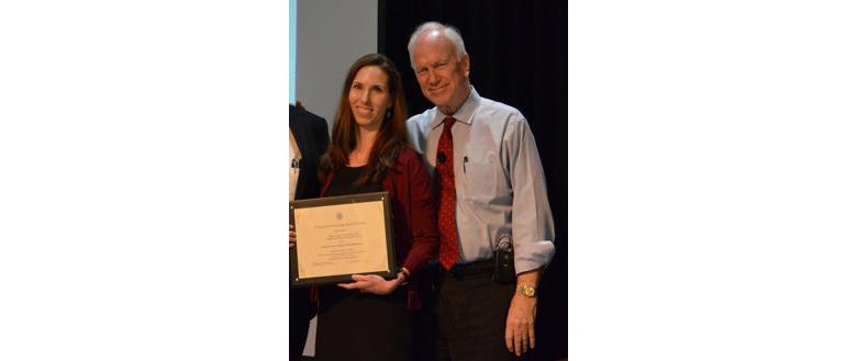 Layman and Dr. Healton stand side by side. Layman holds her award.