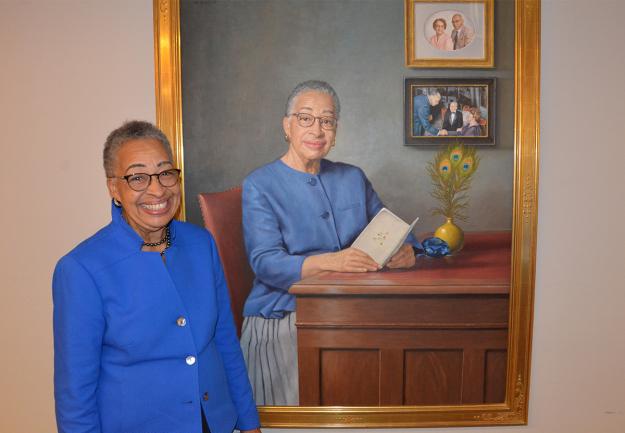 Former Dean Joy Phinizy Williams poses in front of her portrait, painted by James Crowley and sponsored by the Office of the Dean of Medical Education, on October 25 during a dedication and unveiling ceremony at Georgetown University School of Medicine (GUSOM).