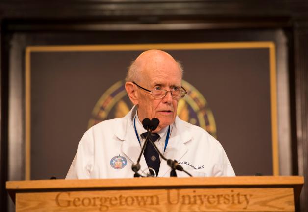 A man speaks at a podium