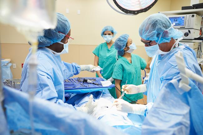 Doctors operate in a surgical suite
