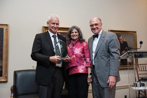 Three individuals stand side by side in a room