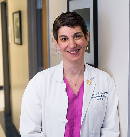 Claudine Isaacs, MD, stands in a hallway