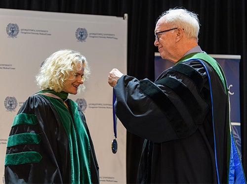 Nora Volkow, MD, accepts the Cura Personalis award from Edward Healton
