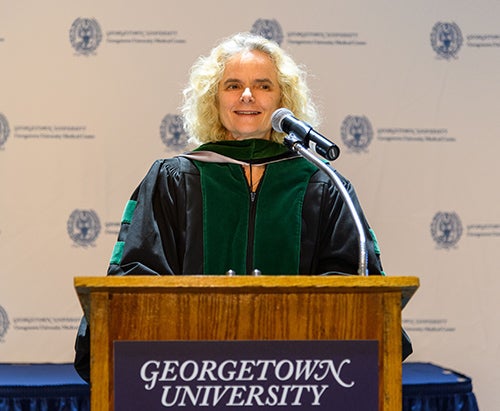 Nora Volkow, MD, speaks at a podium
