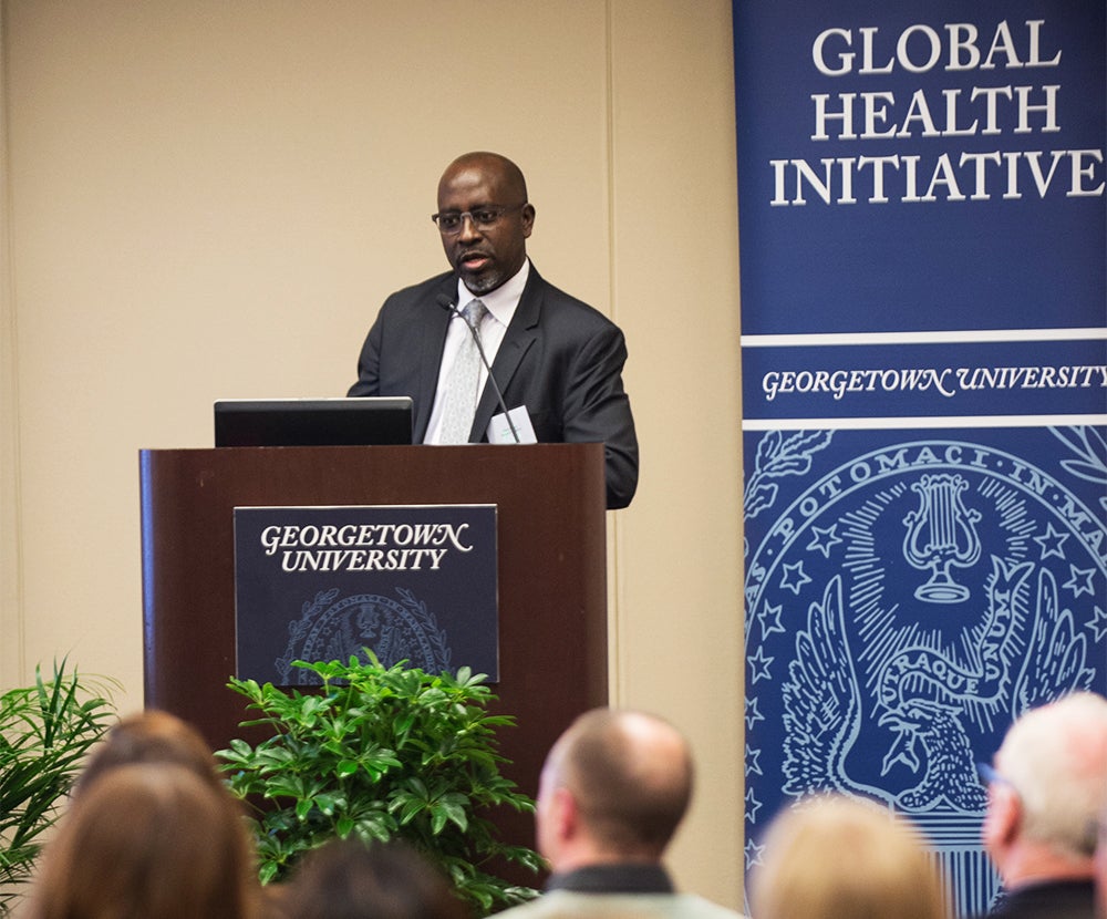 Deus Bazira stands at a podium