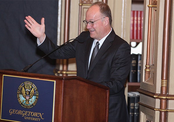 John DeGioia speaks from behind a podium