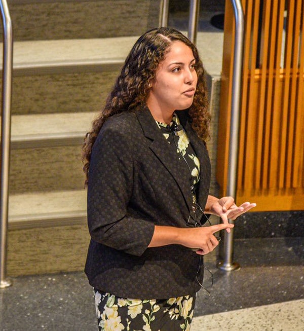 Daniela Butler speaks in an auditorium