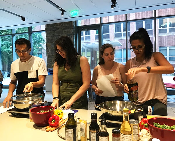 Four students prepare food