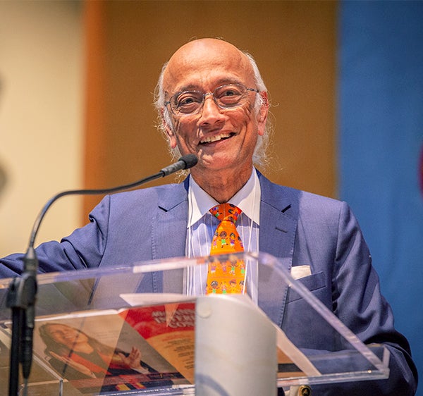 Dr. Subramanian speaks from behind a podium