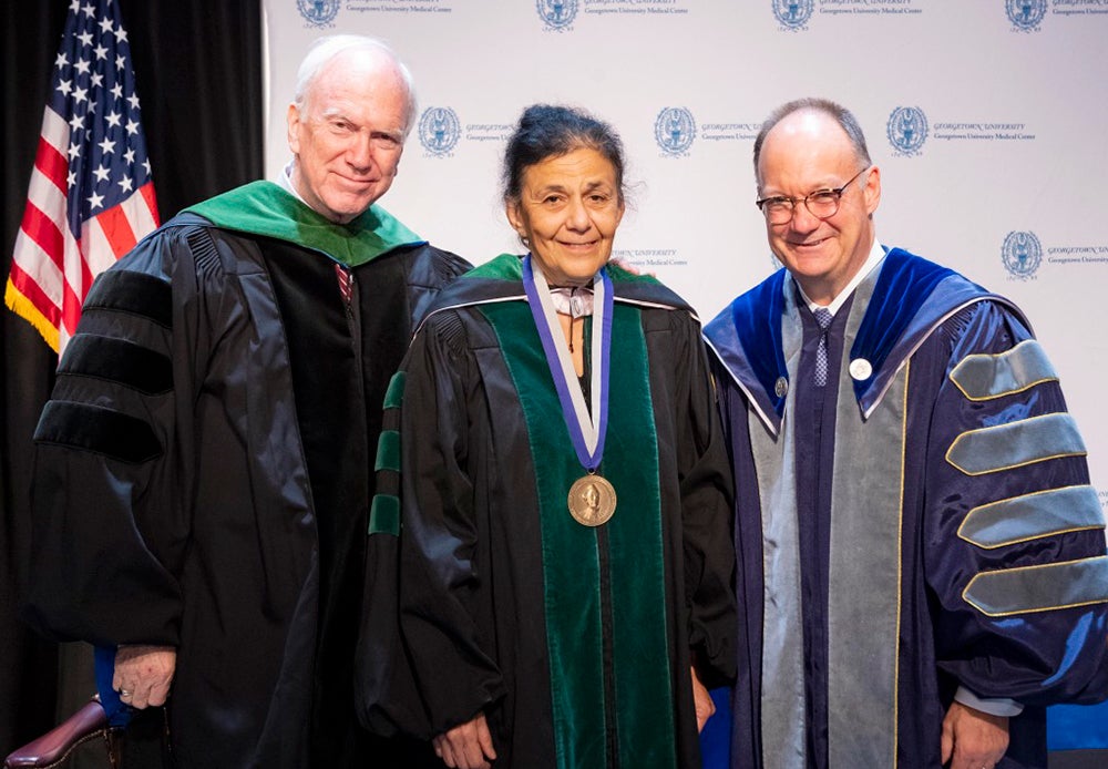 Ed Healton, Wafaa El-Sadr and Jack DeGioia stand side by side onstage