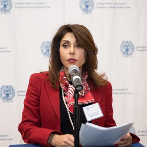 Dr. Golestaneh speaks into a microphone