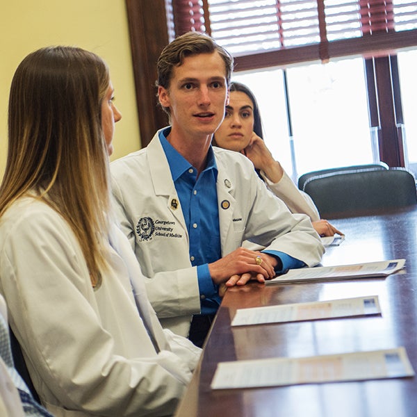 Daniel Swanson speaks at a table in a congressional office