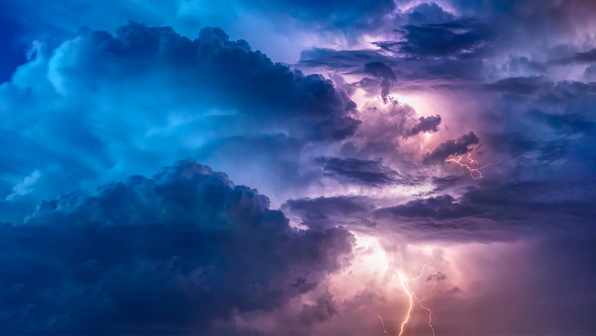 Lightning illuminates the clouds during a thunderstorm