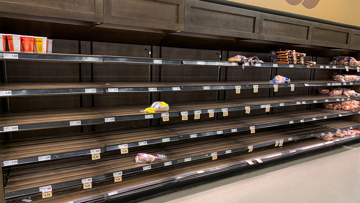 Shelves for bread are mostly empty in a grocery store