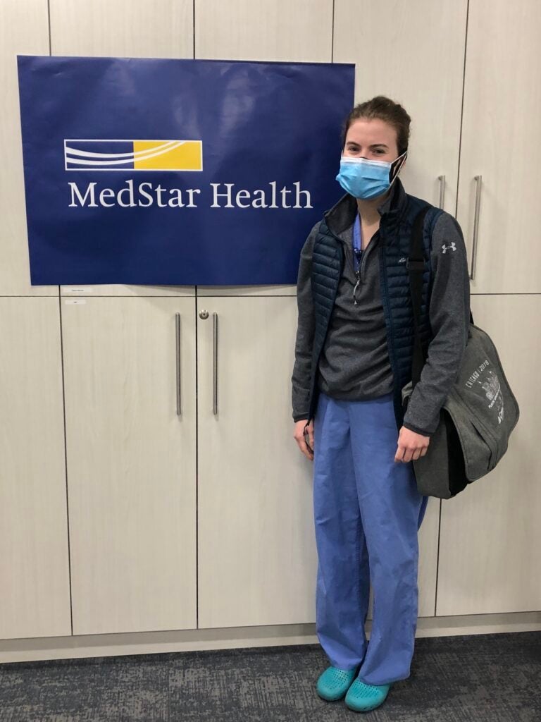 Elizabeth Zolper stands next to a MedStar Health banner