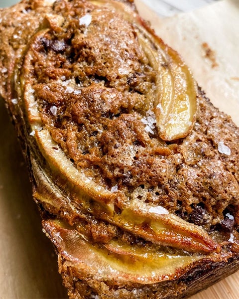 A loaf of banana bread on a cutting board