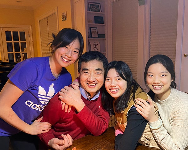 Four members of the Li family together in their home