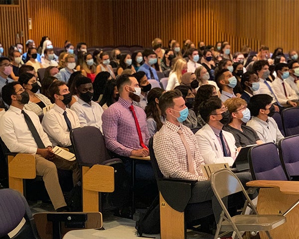 Students sit in an auditorium