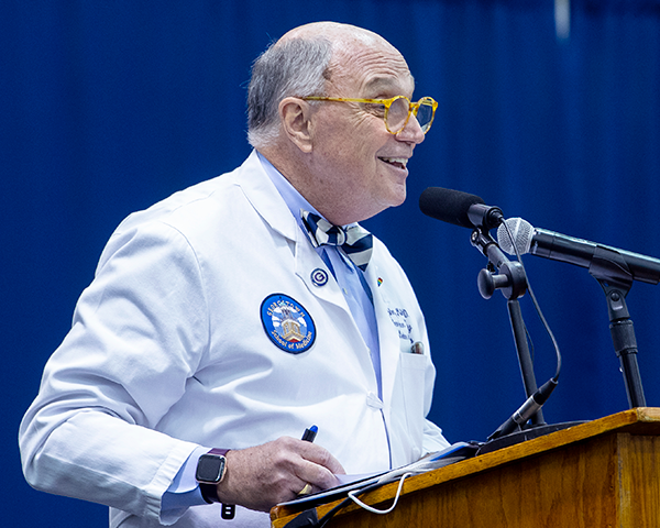 Dr. Mitchell addresses White Coat ceremony attendees from a podium