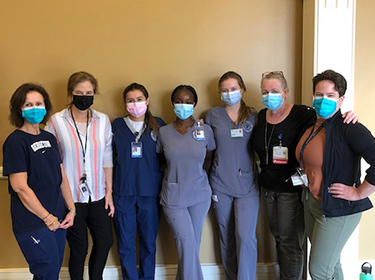 A group of medical professionals stand together in a line