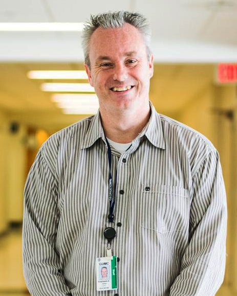 James Granlund, Jr. stands in a hallway at Georgetown