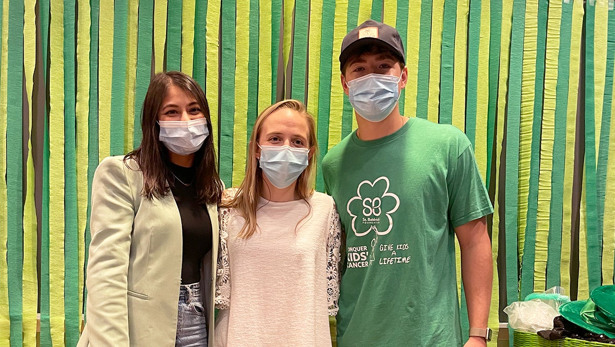 The three St. Baldrick's fundraiser organizers stand side by side