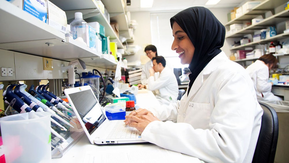 A woman works at a computer in a lab