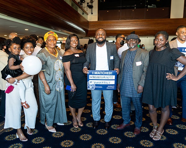 Kojo Sarpong stands with a group of family members at Match Day