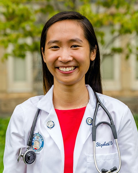 Elizabeth King in her white coat with stethoscope draped around her neck