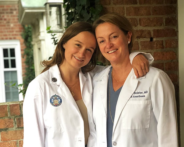 Drew Bolster stands with her arm around her mother