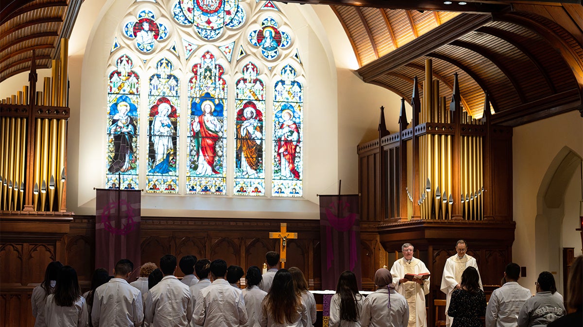 congregants celebrate mass in a church