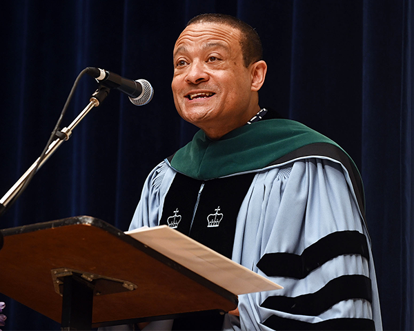 Lee Jones speaks at a podium