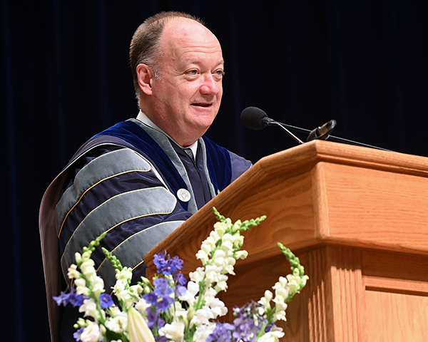 Georgetown President John J. DeGioia speaks from a podium