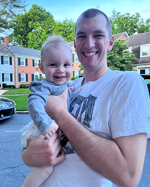 Evan Todd holds his infant son 