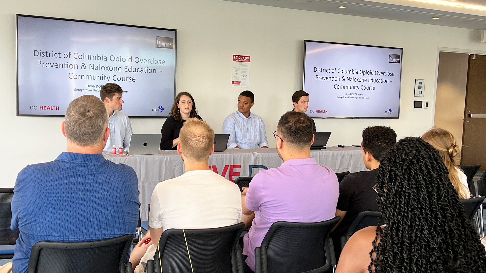Panelists speak to an audience