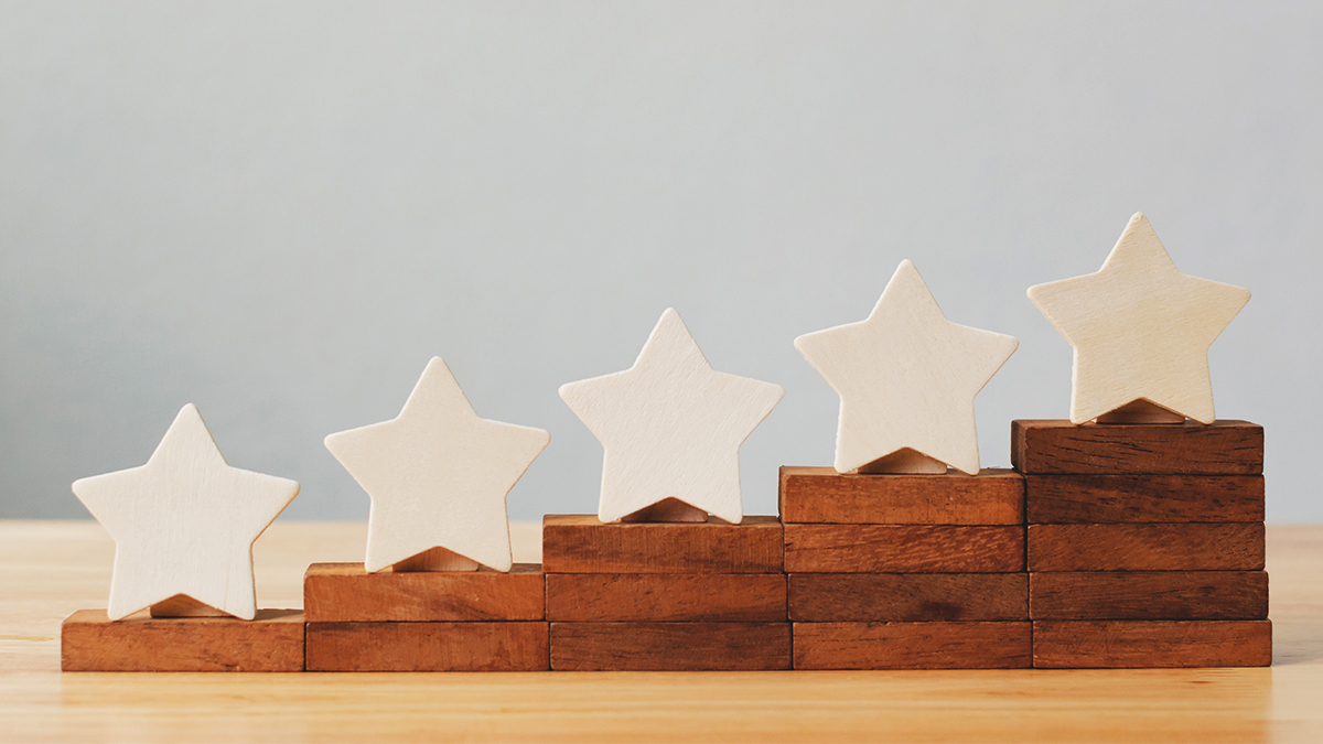 Wooden stars on stacks of blocks that get progressively higher